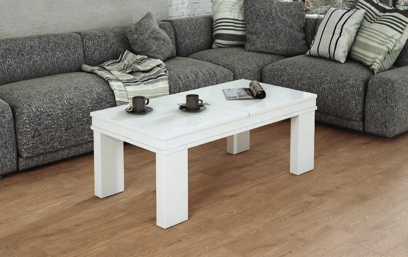 White coffee table in front of a grey corner sofa